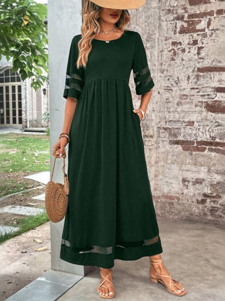 Model wearing the tummy-flattering coverage dress in red, styled for a polished day-to-night look