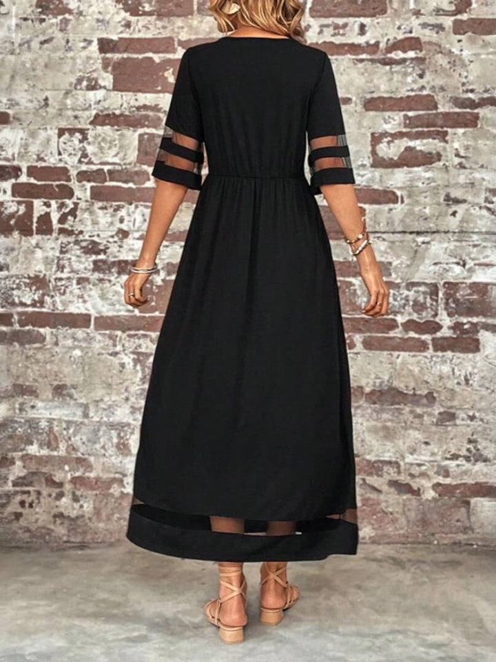 Full-length shot of the tummy-flattering dress in green, showing the length and relaxed elegant flow