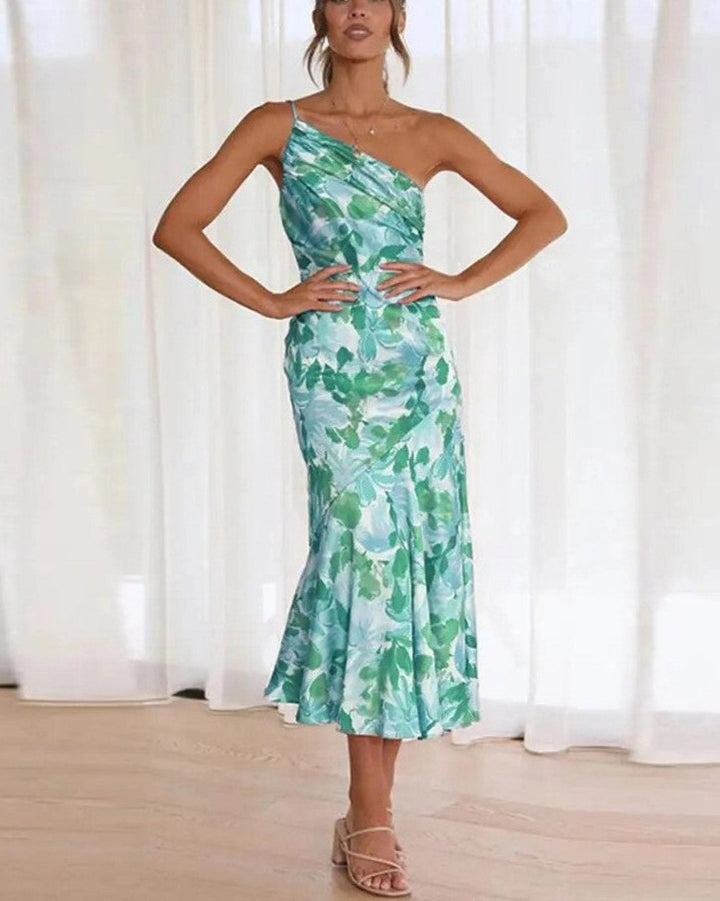 Close-up of orange floral print fabric on a one-shoulder maxi dress