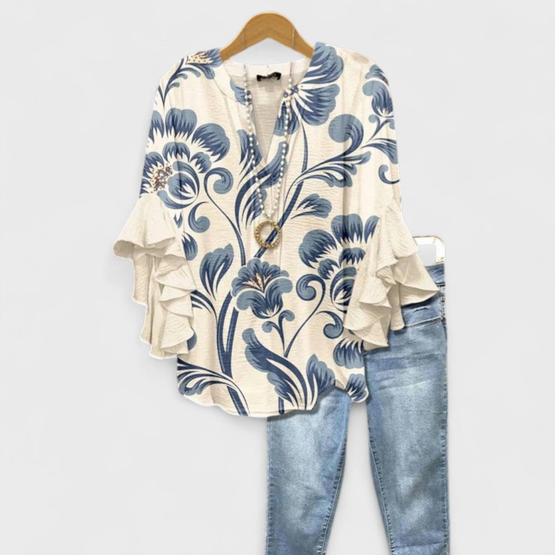 Woman wearing the Kay lightweight day blouse in white, featuring soft feminine detailing and a relaxed silhouette