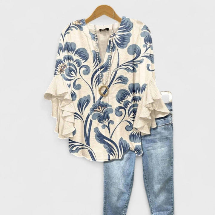 Woman wearing the Kay lightweight day blouse in white, featuring soft feminine detailing and a relaxed silhouette