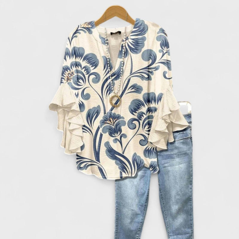 Woman wearing the Kay lightweight day blouse in white, featuring soft feminine detailing and a relaxed silhouette