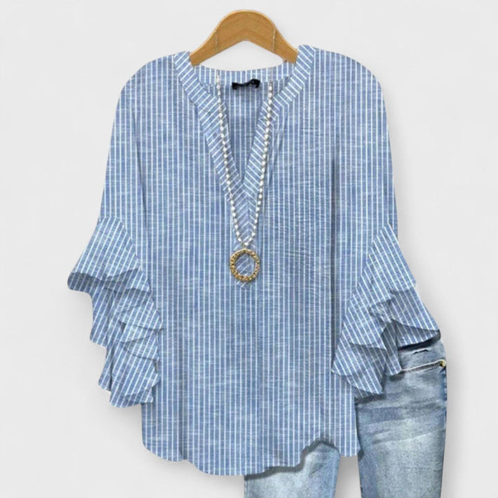 Kay lightweight day blouse in blue displayed on a model, showing the airy fabric and feminine fit