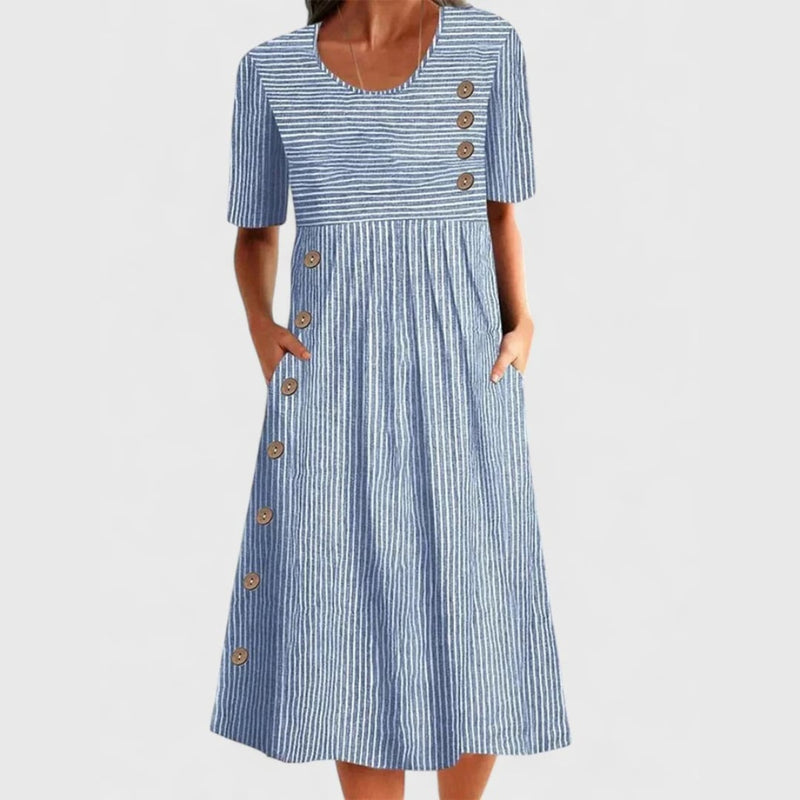 Woman wearing a blue and gray striped midi dress with button-front detail and 3/4 sleeves