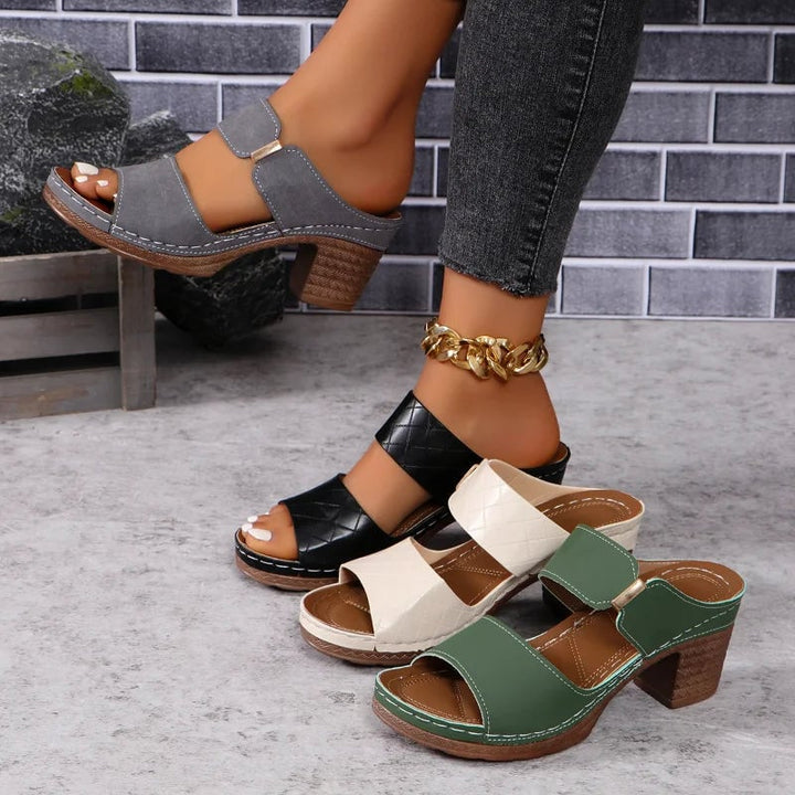 Model wearing Keira green block heel sandals styled with a midi dress