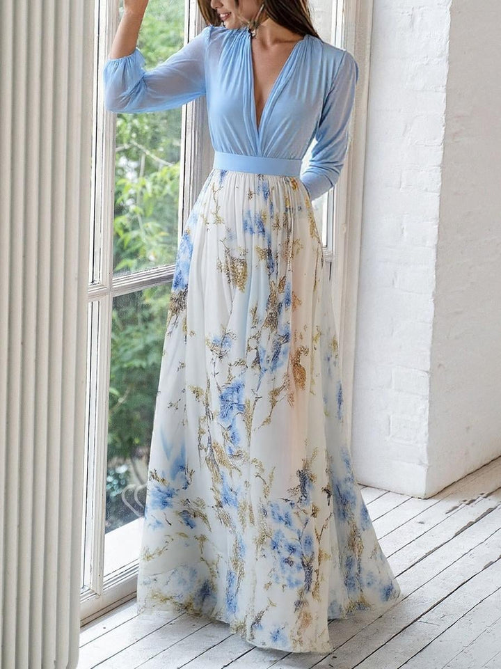 Full-length back view of a woman in a flowing floral maxi dress showing the relaxed fit and length