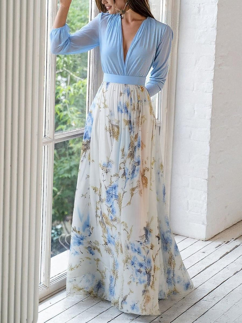 Full-length back view of a woman in a flowing floral maxi dress showing the relaxed fit and length