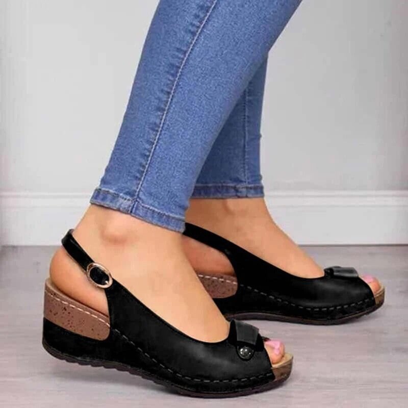 Side view of Kenzie orthopedic sandal in black showing cushioned sole and refined strap design