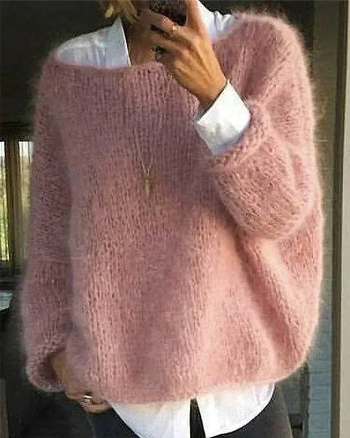 Woman wearing a soft lightweight knitted sweater in a warm neutral tone, styled for casual everyday wear