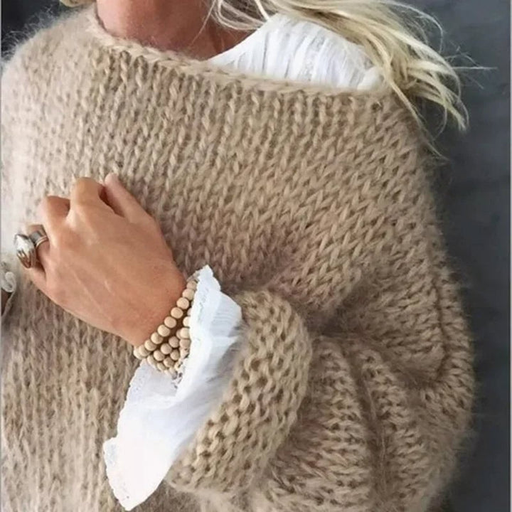 Model wearing the Kerry sweater in green, layered over a casual outfit for a relaxed fall look