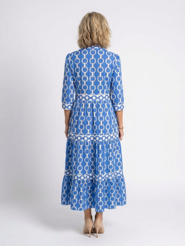 Side view of the Keziah tiered midi dress in blue highlighting the flowing silhouette