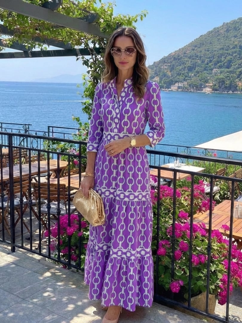 Full-length view of the Keziah chain print midi dress in purple showcasing the tiered design