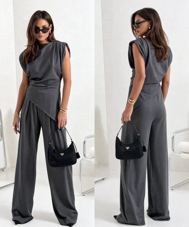 Close-up of the asymmetrical draped neckline on the Khloe two-piece set in light gray