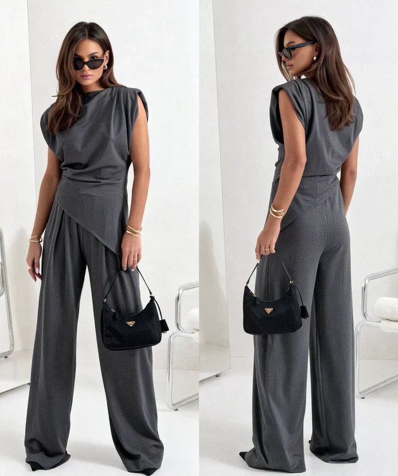 Close-up of the asymmetrical draped neckline on the Khloe two-piece set in light gray