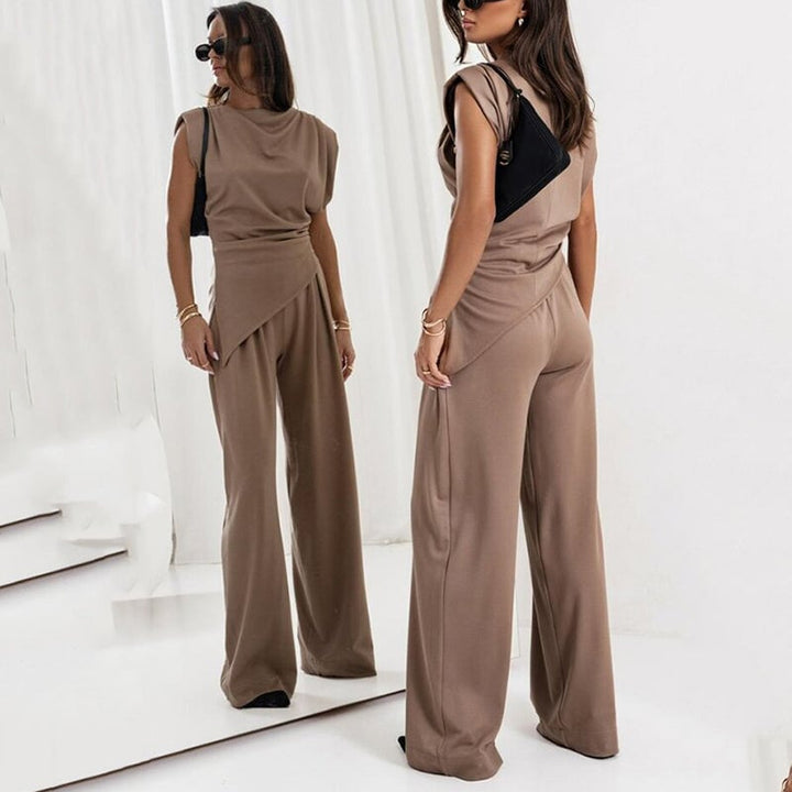 Three-quarter view of the Khloe set in light gray emphasizing the waist-cinching draped top
