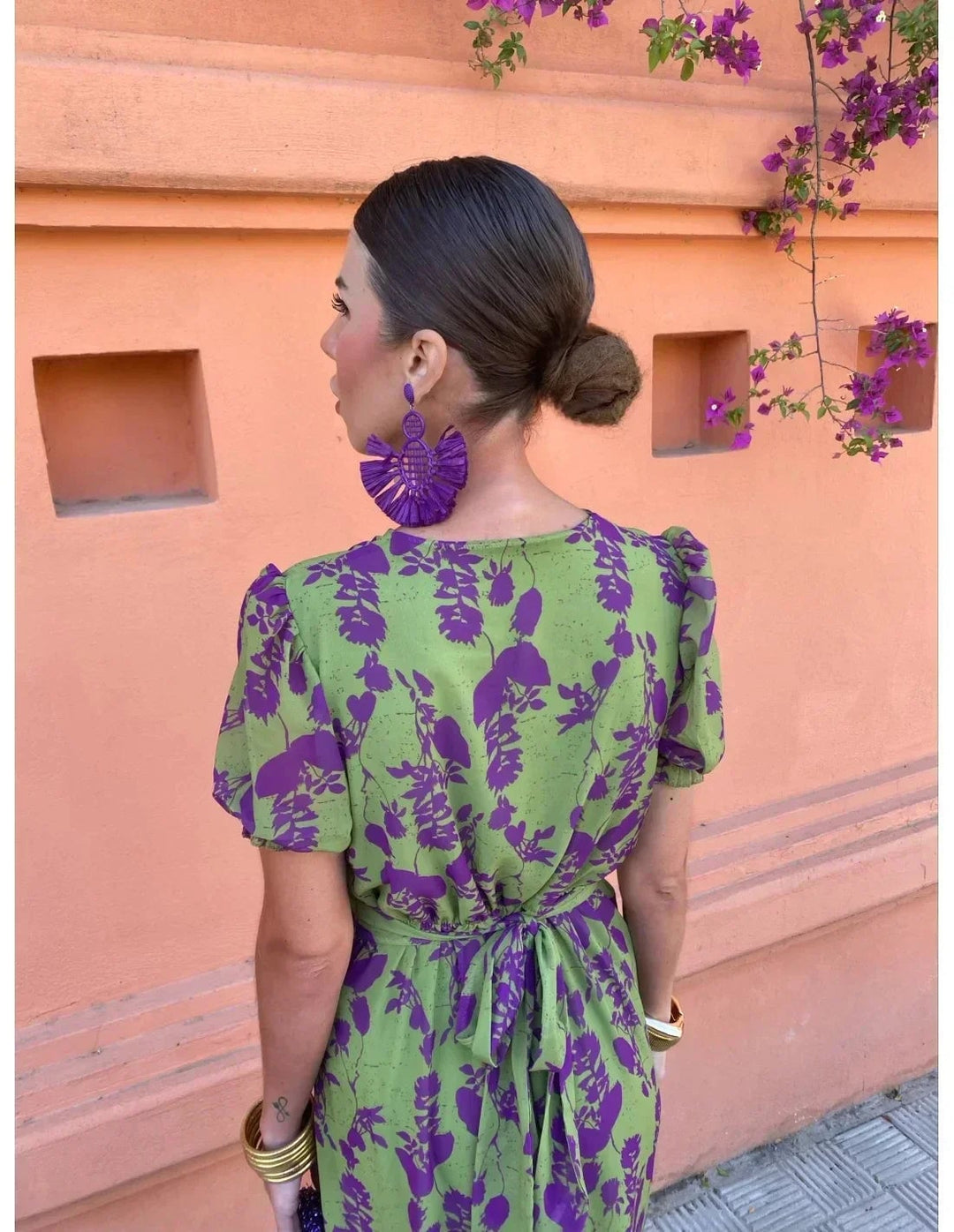 Woman in green Florimay summer dress posing outdoors, showcasing the flowing skirt and modern cut