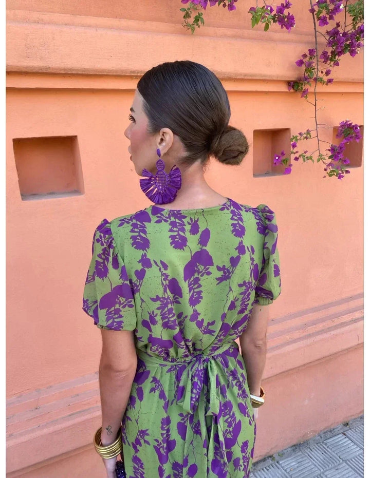 Woman in green Florimay summer dress posing outdoors, showcasing the flowing skirt and modern cut