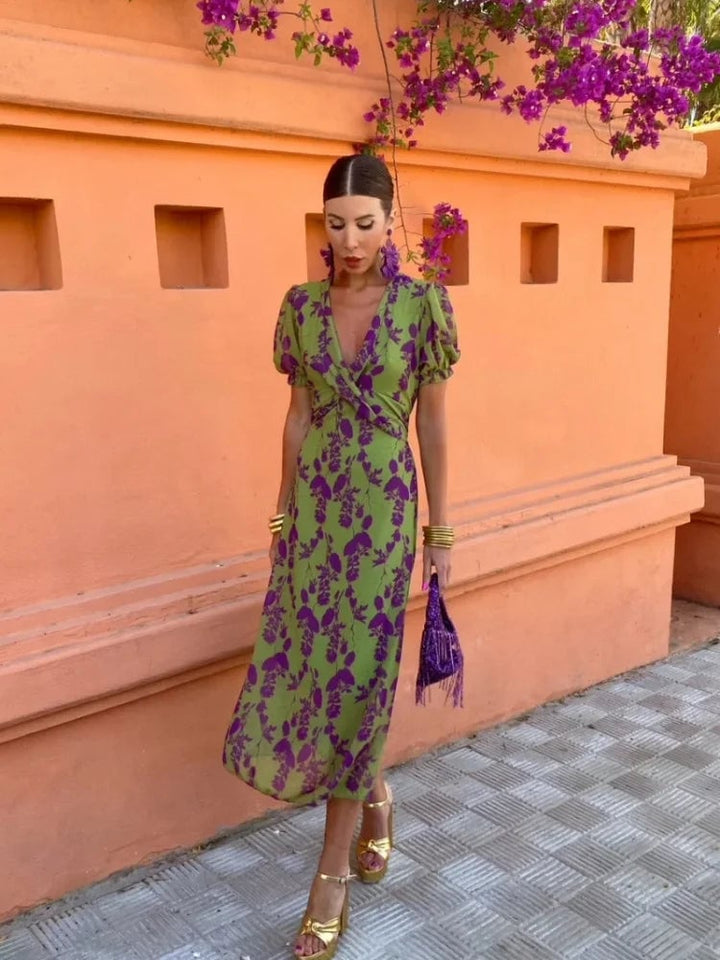 Side view of green summer midi dress highlighting the flattering flowing silhouette