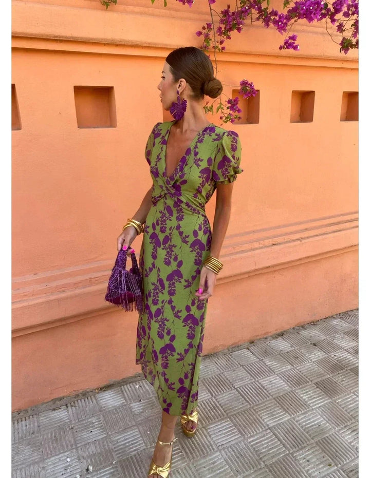 Full-length view of woman in green lightweight midi dress with V-neck and short puff sleeves