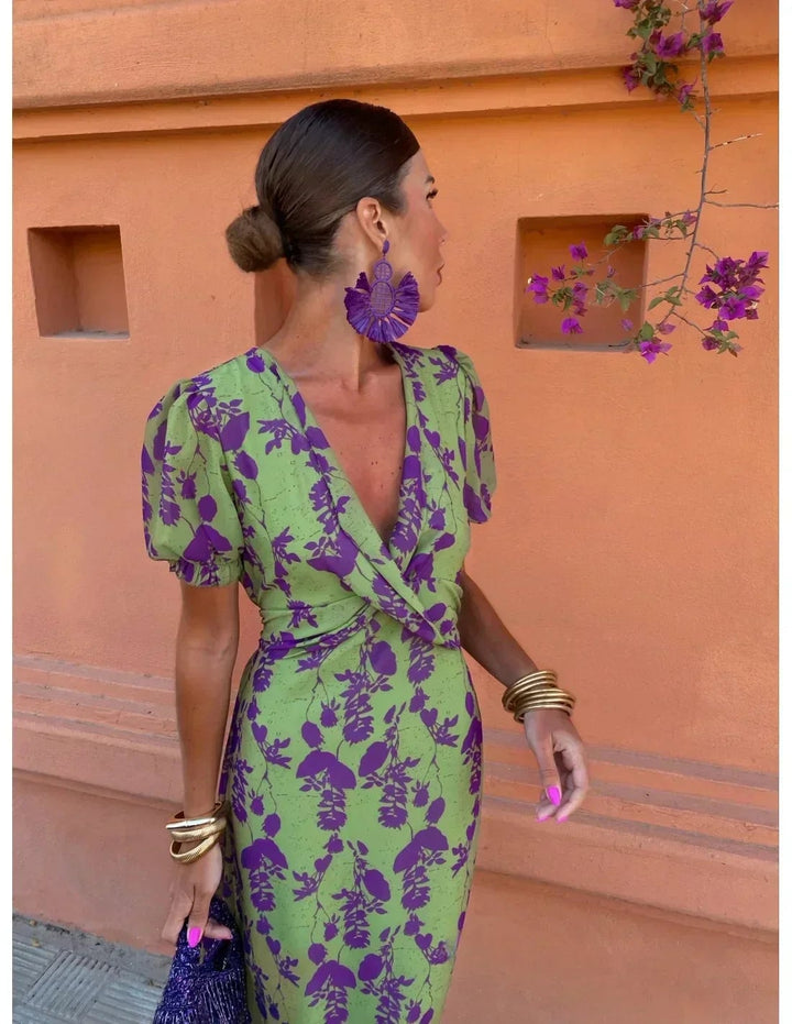 Woman styling the green Florimay summer dress with sandals for a casual daytime look