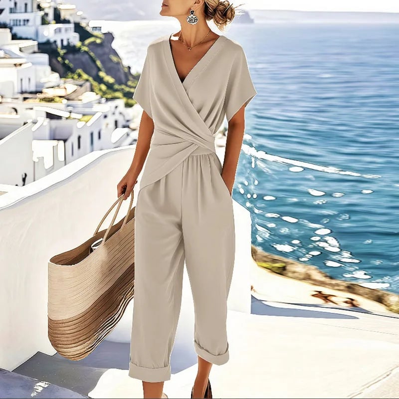 Woman wearing an elegant wrap-front top and cropped trouser two-piece set in apricot