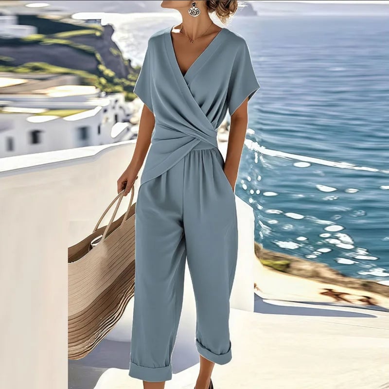 Close-up detail of the wrap-front neckline and tailored trousers of the two-piece set