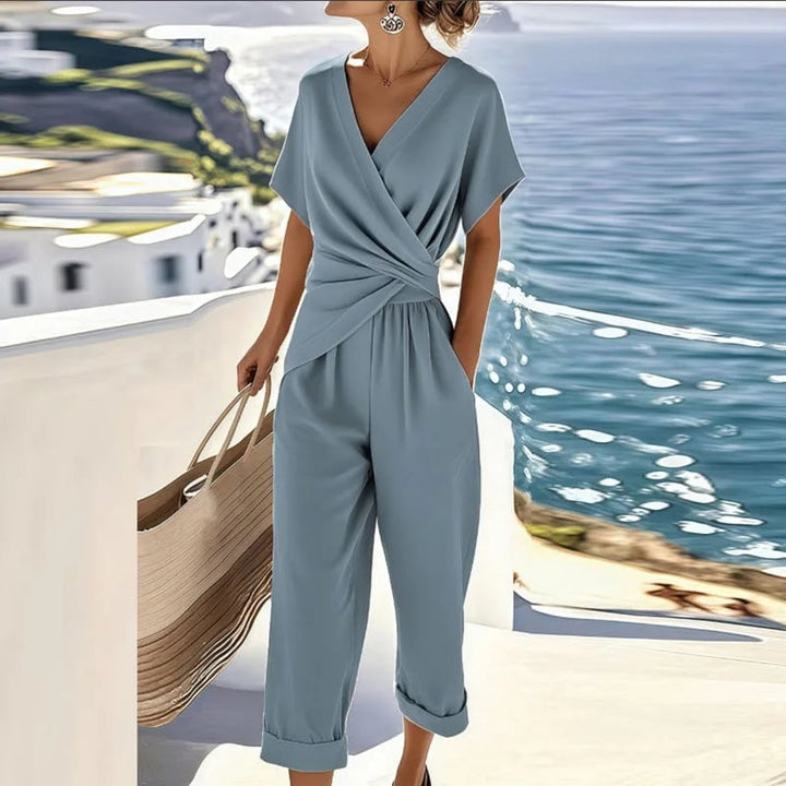 Close-up detail of the wrap-front neckline and tailored trousers of the two-piece set