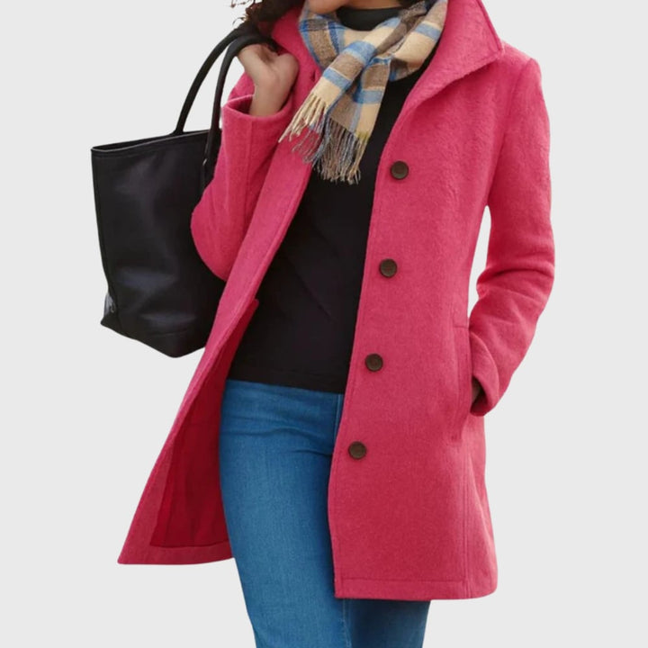 Kimmy longline coat in pink worn over a dress for a chic, layered ensemble