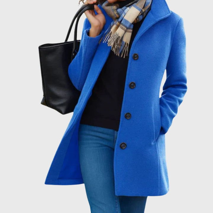 Full-length view of the Kimmy longline coat in blue showing the elongated hemline and clean design
