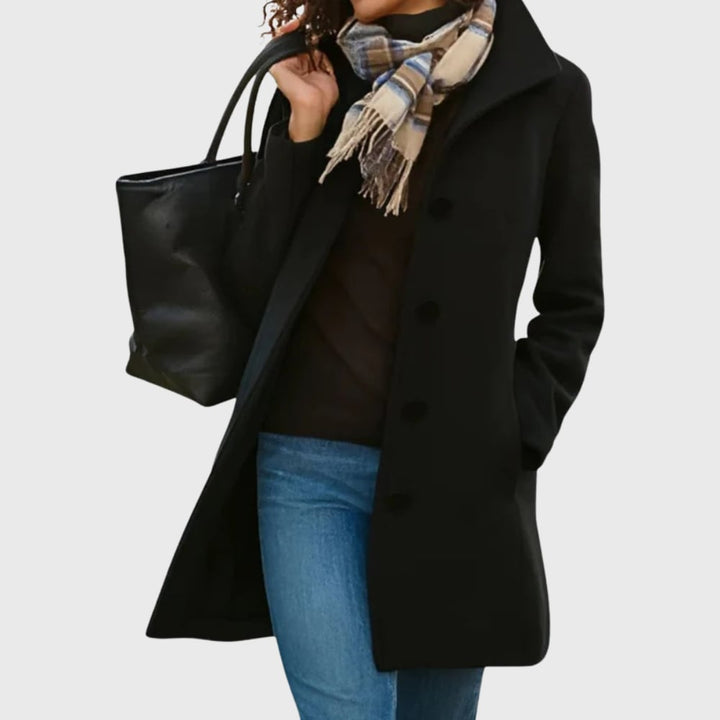 Woman wearing the Kimmy longline coat in black for a classic, sophisticated outerwear look
