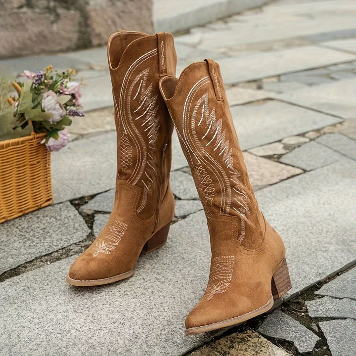 Women's white suede cowboy boots with block heel styled with a flowy midi skirt