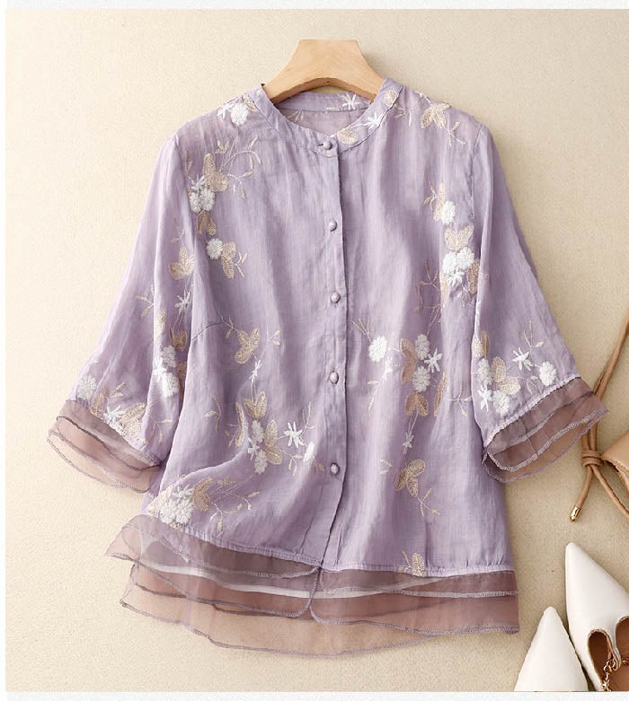 Side view of a woman wearing a light green floral blouse with a flowy relaxed fit