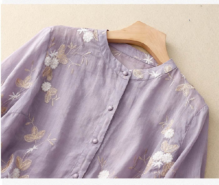 Model styling a purple floral blouse with a midi skirt for an elevated look