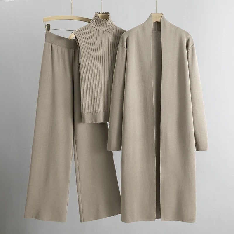 Model wearing the Krista three-piece sweater set in beige, including sleeveless vest, sweater, and relaxed trousers