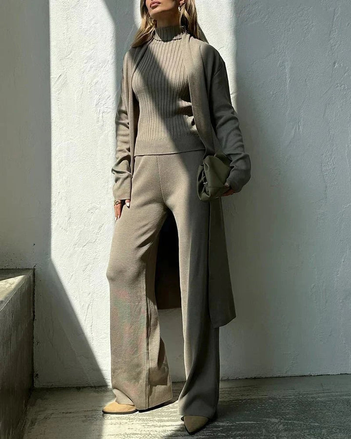Detail shot of Krista sweater set trousers and vest in black colorway against a clean background