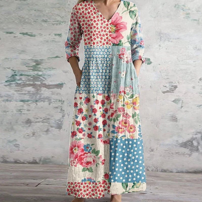 Model wearing a light blue retro floral maxi dress with a flowing skirt and contoured bodice