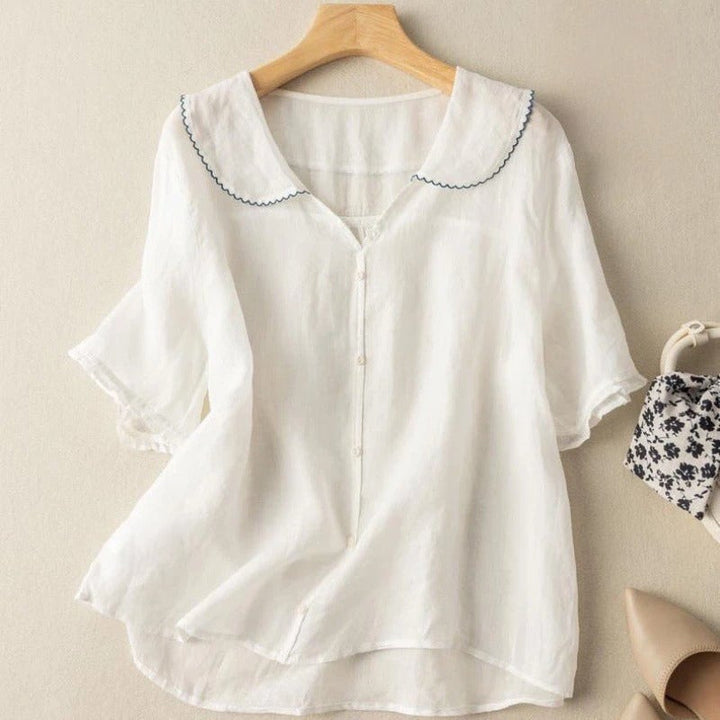 Side view of a woman wearing the Kristi vintage button blouse highlighting the airy fit and collar detail