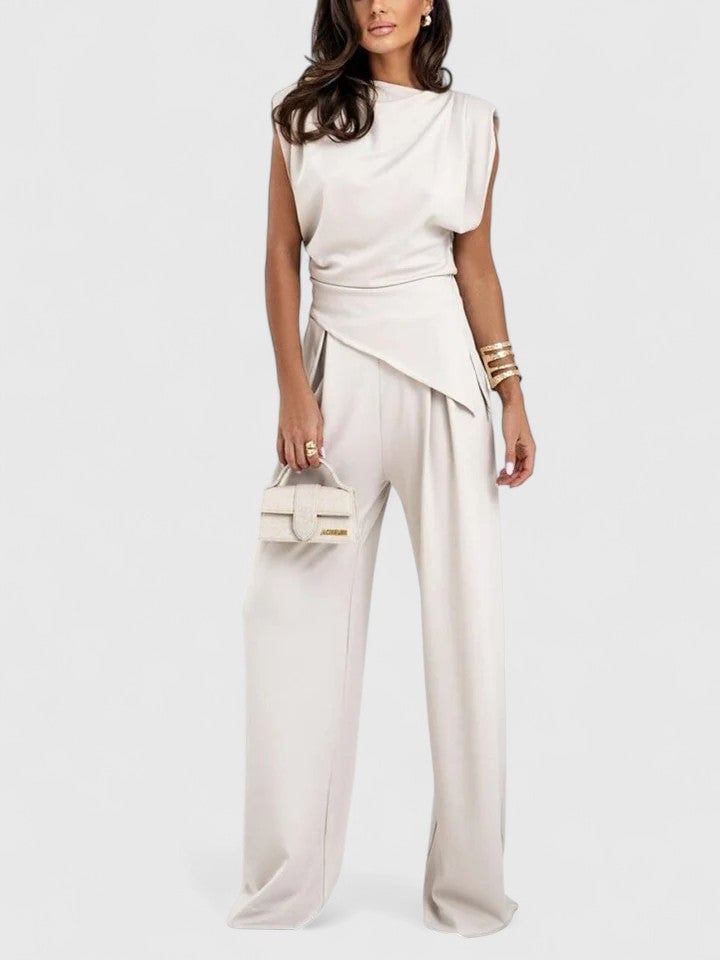 Woman wearing the Laiza draped two-piece wide-leg pants set in peach with asymmetric wrap top