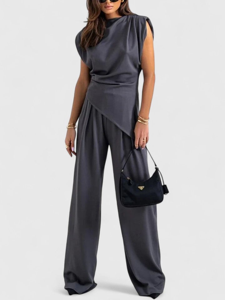 Close-up of the twisted asymmetric drape detail at the waist of the Laiza top in peach