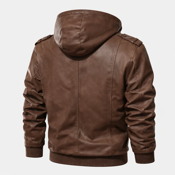 Close-up detail of the brown hooded jacket showing water-repellent fabric texture and secure pocket design