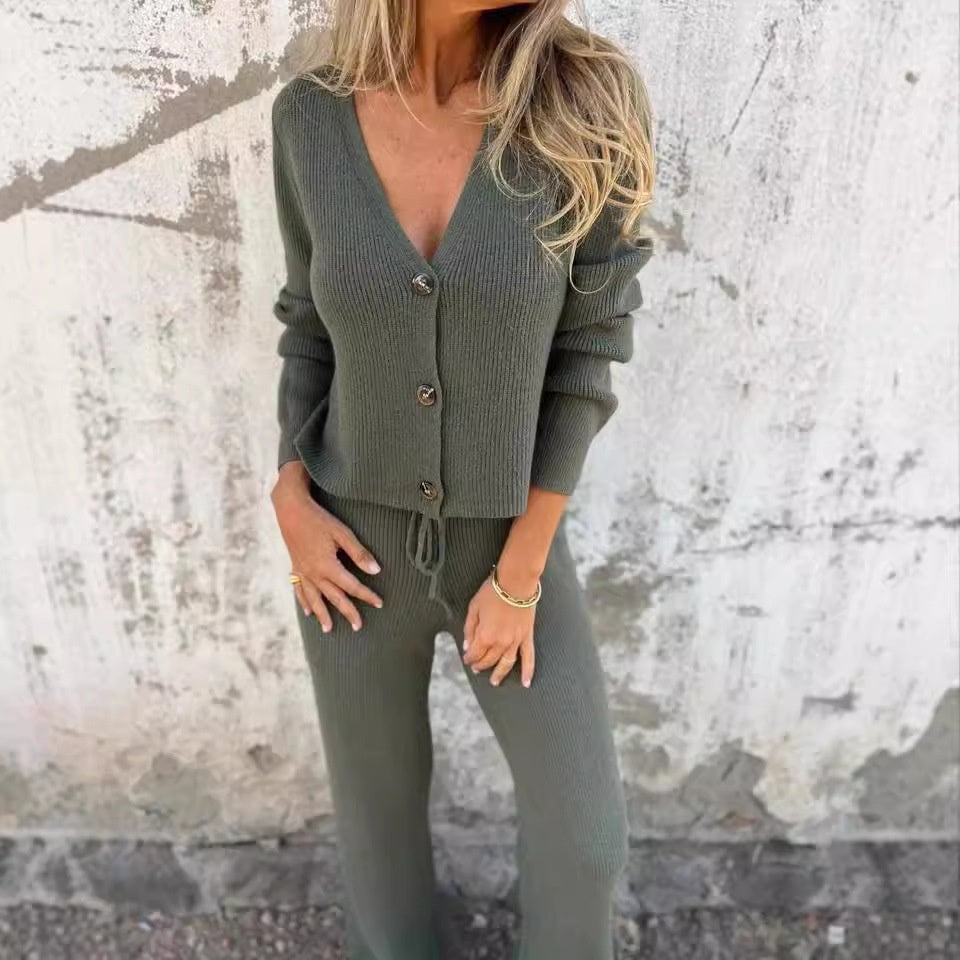 Woman in black 2-piece cardigan set standing in a relaxed pose, showcasing the coordinated outfit