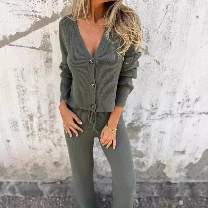 Woman in black 2-piece cardigan set standing in a relaxed pose, showcasing the coordinated outfit