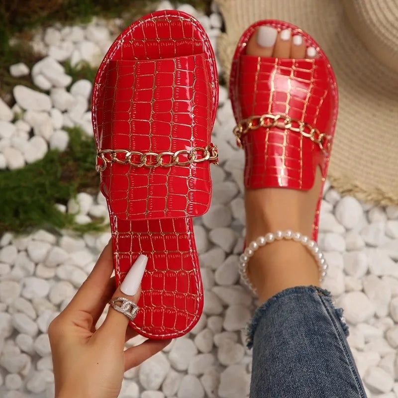 Side view of Lark women's sandals showing sleek croc-embossed texture and elegant silhouette