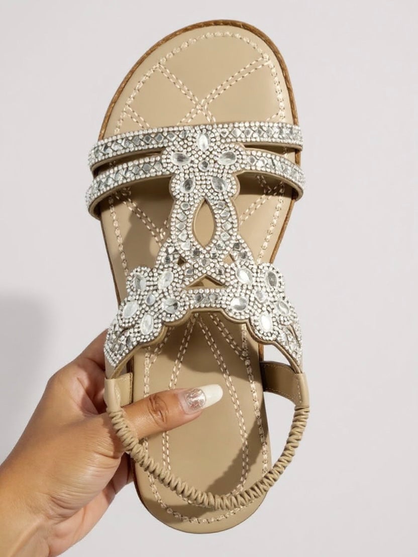 Larkspur sparkle sandals in gold catching warm light from a side angle