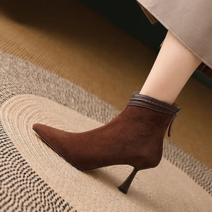 Pair of Laura ankle boots in black and brown displayed side by side on a neutral background