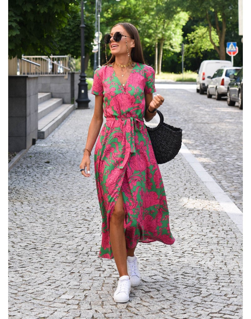 Woman wearing the Lauri floral dress in pink, showing a flowing silhouette with a delicate floral print