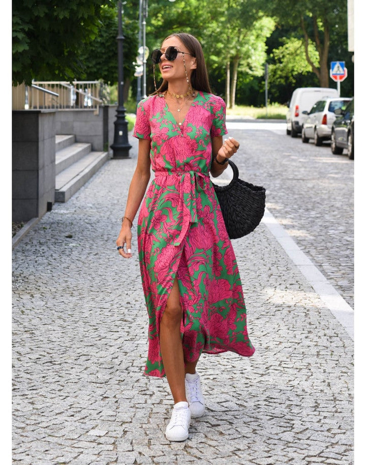 Woman wearing the Lauri floral dress in pink, showing a flowing silhouette with a delicate floral print