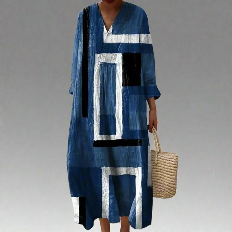 Woman wearing the Leah elegant geometric print dress in a flowing silhouette that flatters every figure