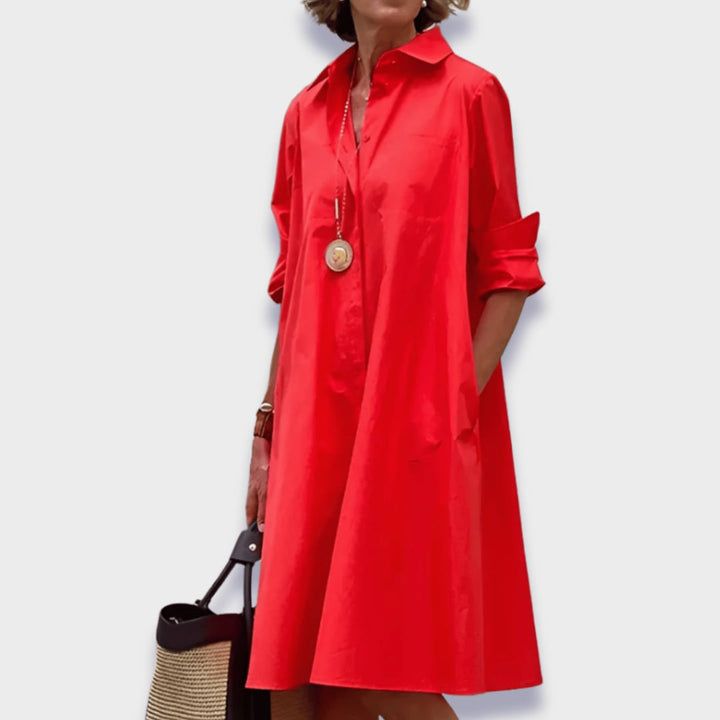 Woman wearing an elegant midi polo dress in a relaxed, flattering silhouette with a classic polo collar