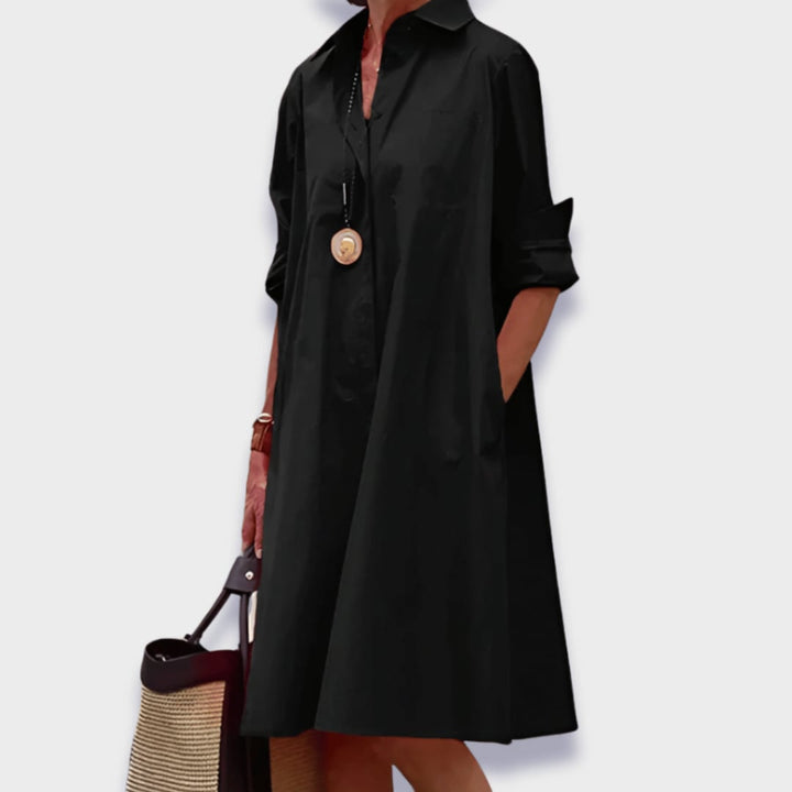 Close-up detail of the polo collar and lightweight fabric on a midi dress in a warm color